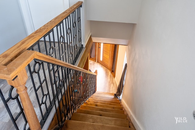 staircase with wood finished floors