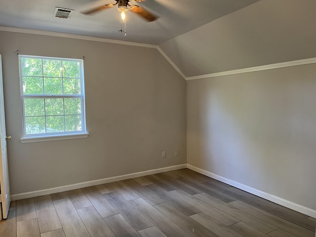 additional living space featuring visible vents, wood finished floors, baseboards, a ceiling fan, and a wealth of natural light