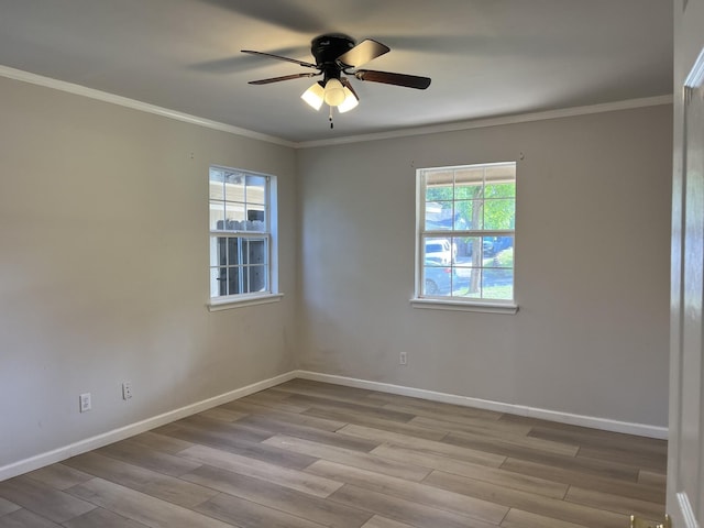 spare room featuring crown molding, a ceiling fan, baseboards, and wood finished floors