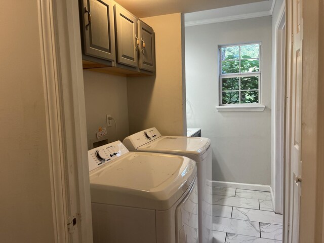 washroom with ornamental molding, marble finish floor, washer and dryer, baseboards, and cabinet space