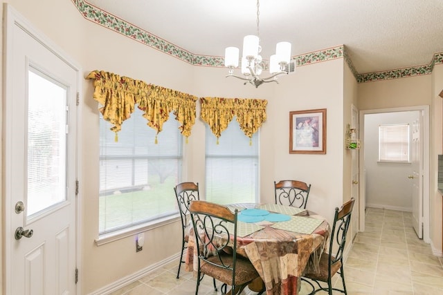 dining space featuring light tile patterned flooring, baseboards, and a chandelier