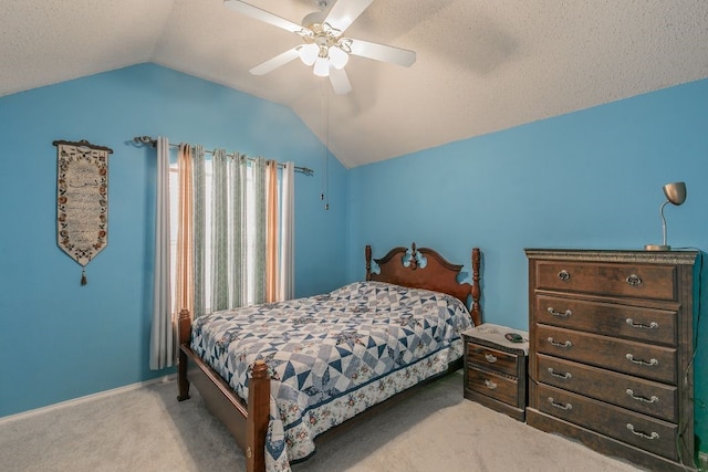 bedroom with ceiling fan, vaulted ceiling, and light colored carpet