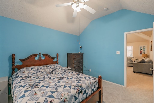 bedroom featuring ceiling fan, vaulted ceiling, baseboards, and carpet