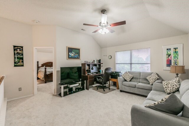 carpeted living area featuring baseboards, visible vents, a ceiling fan, and lofted ceiling