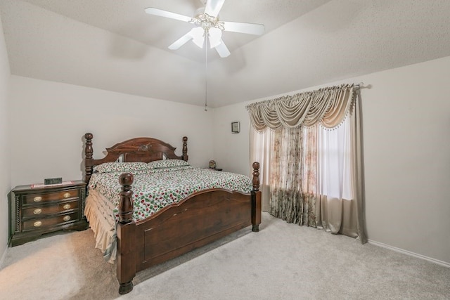 bedroom with vaulted ceiling, a ceiling fan, and carpet flooring