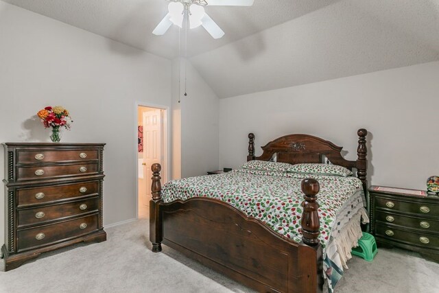 bedroom featuring a ceiling fan, lofted ceiling, and light colored carpet