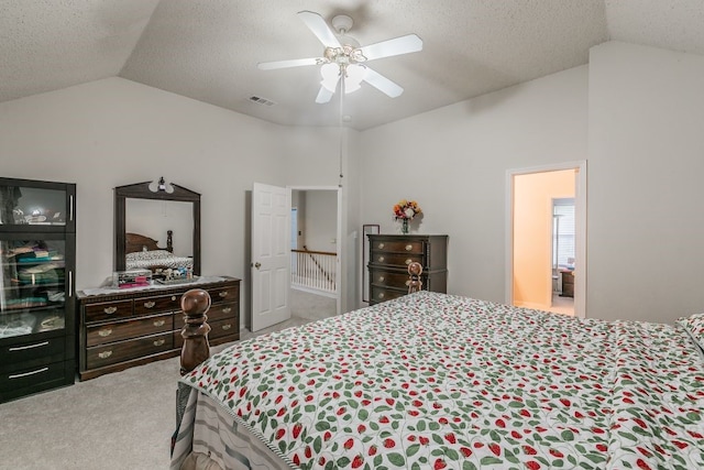 bedroom featuring carpet flooring, a textured ceiling, visible vents, and lofted ceiling