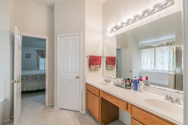 ensuite bathroom featuring double vanity, a sink, ensuite bath, and a tub to relax in