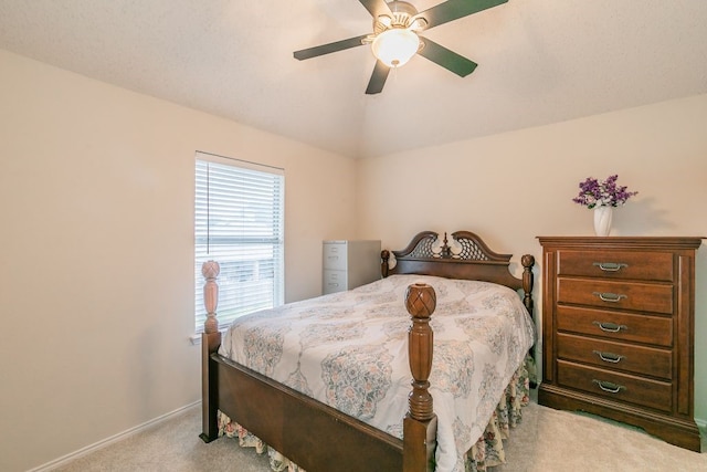 carpeted bedroom featuring baseboards, ceiling fan, and lofted ceiling