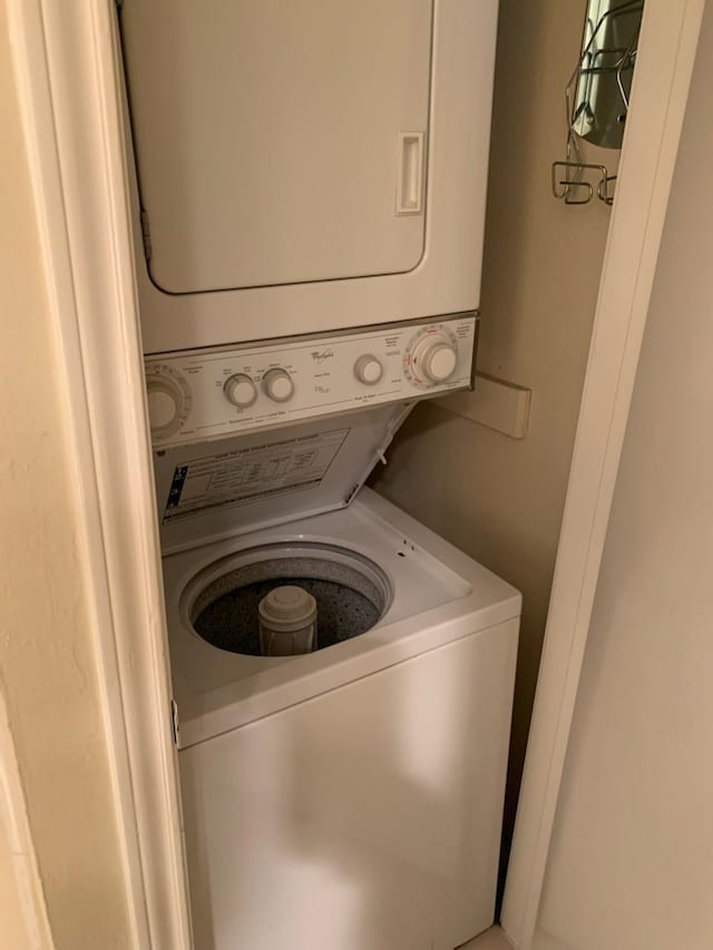 laundry area with laundry area and stacked washer / dryer