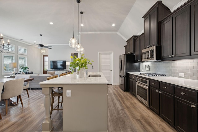920 Plaza Ln, Argyle, TX 76226 - kitchen with appliances with stainless steel finishes, ornamental molding, wood finished floors, ceiling fan, and backsplash