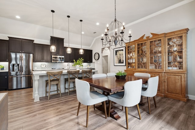 920 Plaza Ln, Argyle, TX 76226 - dining room with light wood-style flooring, crown molding, a chandelier, and recessed lighting