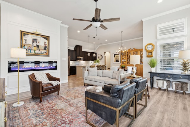 920 Plaza Ln, Argyle, TX 76226 - living area featuring light wood finished floors, a ceiling fan, recessed lighting, a chandelier, and crown molding