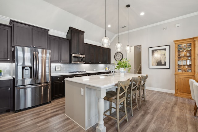 920 Plaza Ln, Argyle, TX 76226 - kitchen featuring appliances with stainless steel finishes, light countertops, light wood-style flooring, tasteful backsplash, and ornamental molding
