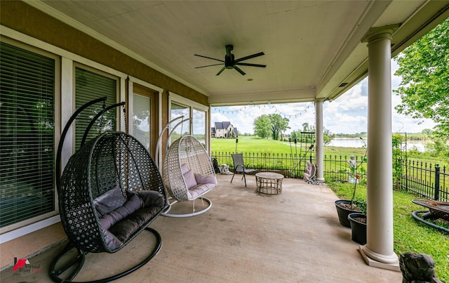 view of patio / terrace with ceiling fan and fence