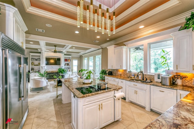 kitchen with crown molding, a ceiling fan, and built in fridge