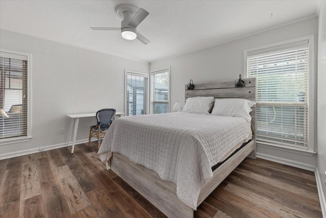 bedroom featuring ceiling fan, baseboards, ornamental molding, and wood finished floors