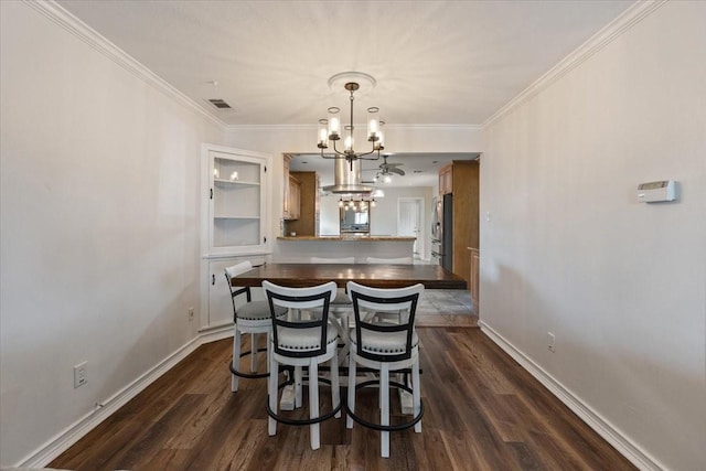 dining area with baseboards, a notable chandelier, dark wood finished floors, and visible vents