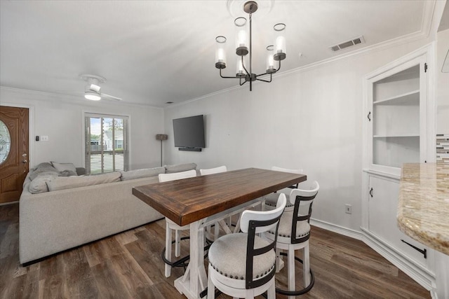 dining area featuring crown molding, dark wood-style flooring, and visible vents