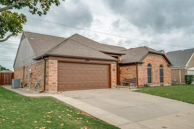 view of front of house featuring brick siding, an attached garage, roof with shingles, and central AC