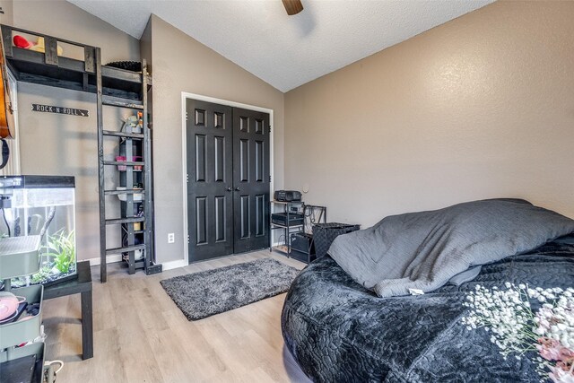 interior space featuring a ceiling fan, wood finished floors, and lofted ceiling