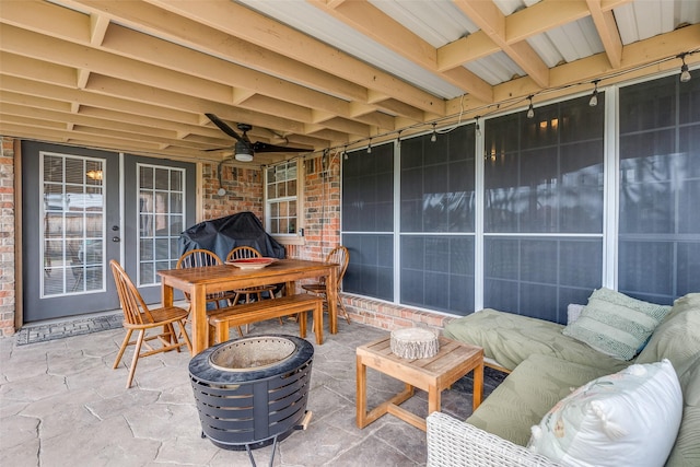 view of patio with french doors, outdoor dining space, and ceiling fan