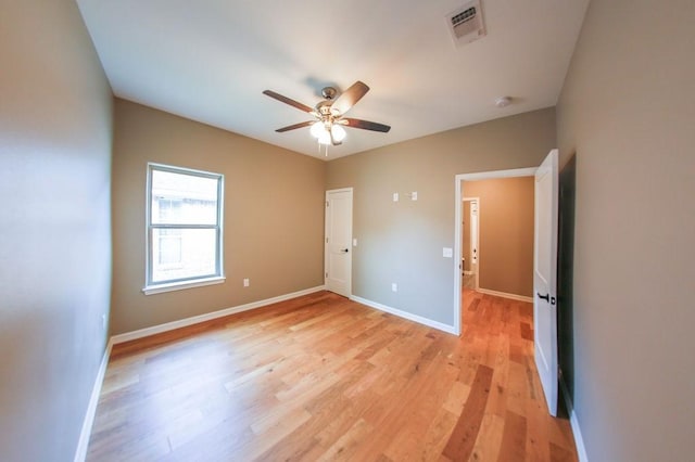 unfurnished bedroom with visible vents, a ceiling fan, light wood-style floors, and baseboards