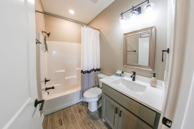 bathroom featuring shower / bath combo, vanity, toilet, wood finished floors, and visible vents