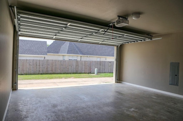 garage with a garage door opener and electric panel