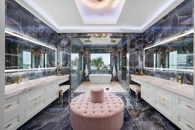 full bathroom with tile walls, two vanities, and a sink