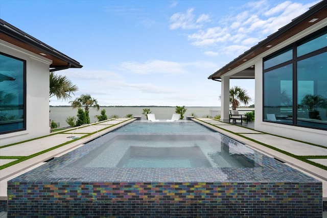 view of swimming pool featuring an in ground hot tub