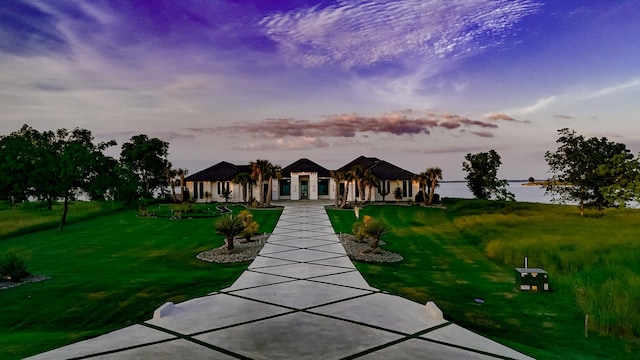 view of front facade with a water view, a gazebo, and a yard