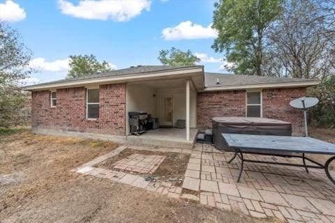 250 Ashland Dr, Woodway, TX 76712 - rear view of property featuring a covered hot tub, a patio, and brick siding