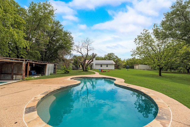 outdoor pool featuring a lawn and an outdoor structure