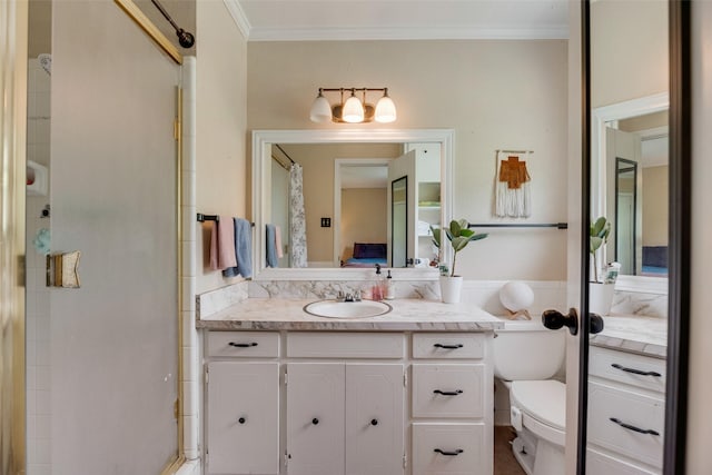 ensuite bathroom featuring crown molding, vanity, toilet, and connected bathroom