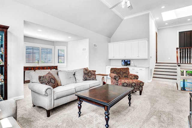 living area featuring visible vents, ornamental molding, light carpet, baseboards, and plenty of natural light