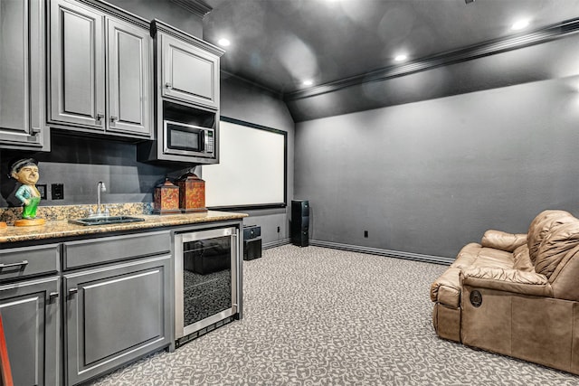 kitchen with crown molding, a sink, stainless steel microwave, wine cooler, and recessed lighting