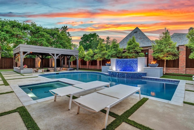 view of swimming pool with an in ground hot tub, a patio, a gazebo, and a fenced backyard