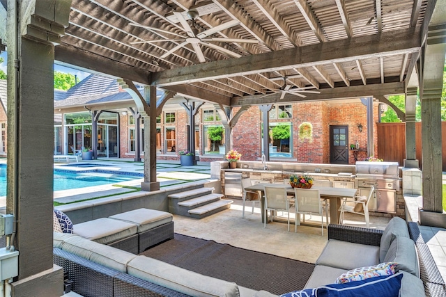 view of patio with ceiling fan, outdoor lounge area, an outdoor pool, outdoor dining area, and a sink