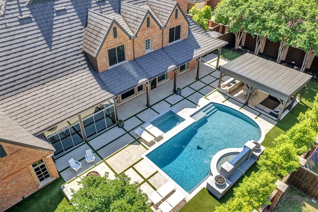 view of pool with a gazebo, a fenced backyard, a jacuzzi, and a fenced in pool