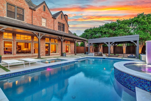 pool featuring an in ground hot tub, a patio, a gazebo, and a fenced backyard