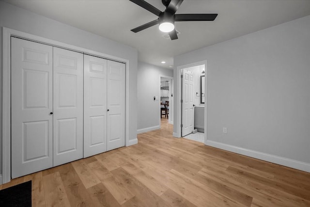 unfurnished bedroom with a closet, baseboards, recessed lighting, connected bathroom, and light wood-style flooring