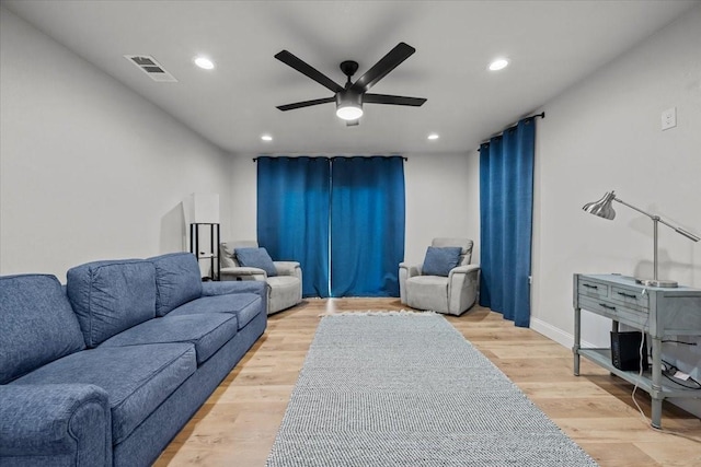 living room featuring visible vents, baseboards, ceiling fan, recessed lighting, and light wood-type flooring