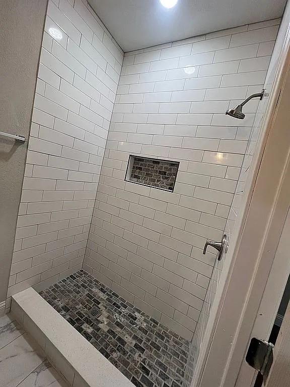 1633 Stoneman, Dallas, TX 75215 - full bathroom featuring a shower stall and marble finish floors