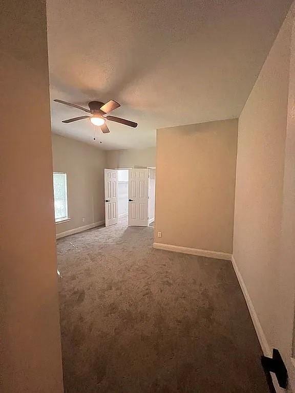 1633 Stoneman, Dallas, TX 75215 - carpeted spare room with baseboards and ceiling fan