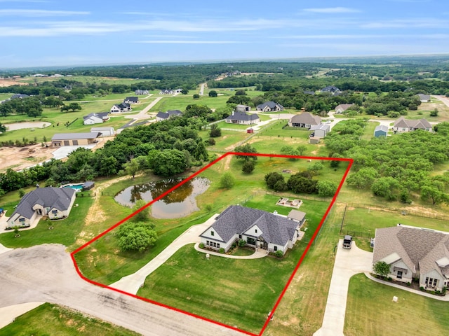 birds eye view of property featuring a water view and a residential view