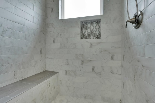 full bath with a tile shower