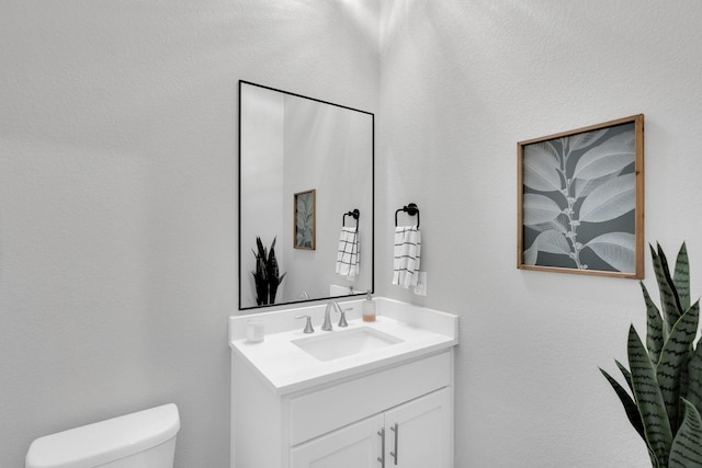 half bath with vanity and toilet