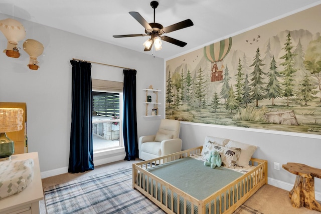 carpeted bedroom with ceiling fan and baseboards