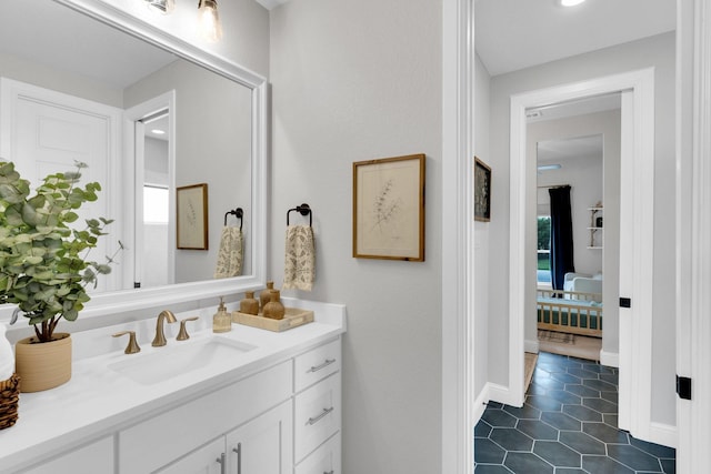 bathroom featuring tile patterned floors, plenty of natural light, baseboards, and vanity